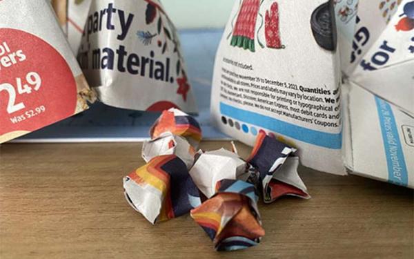 A small origami folded newspaper ad for a grocery store